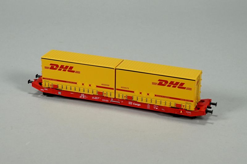 Spielzeug-Eisenbahn-Niederbordwagen mit zwei LKW-Wechselbrücken von DHL
